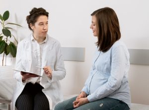 Womans Certified Specialist Sitting with Patient